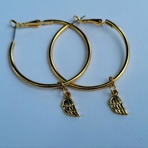 Gold hoops with wing charm